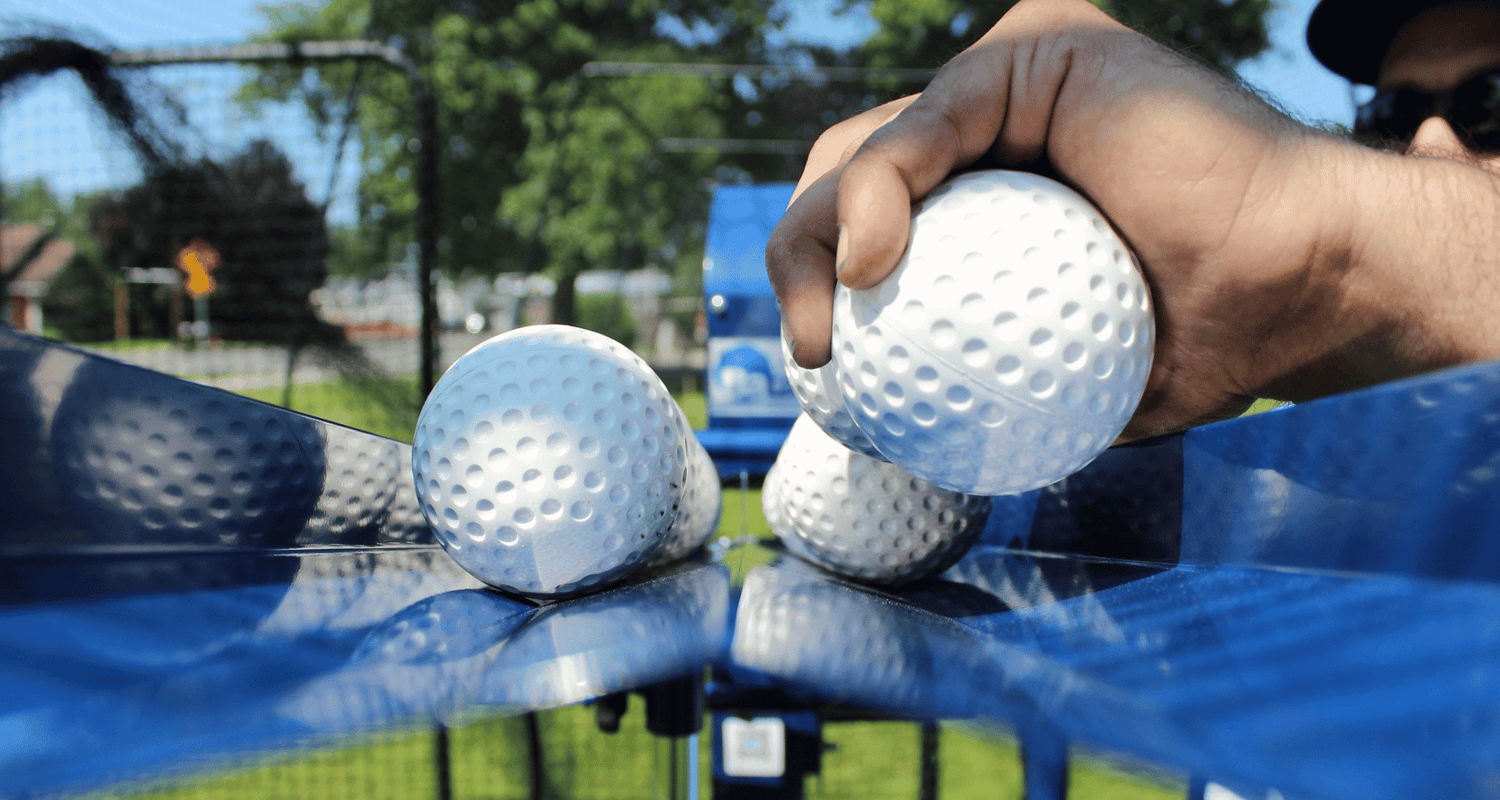 Why We Recommend Low Seam or Dimpled Baseballs For Your Pitching Machine
