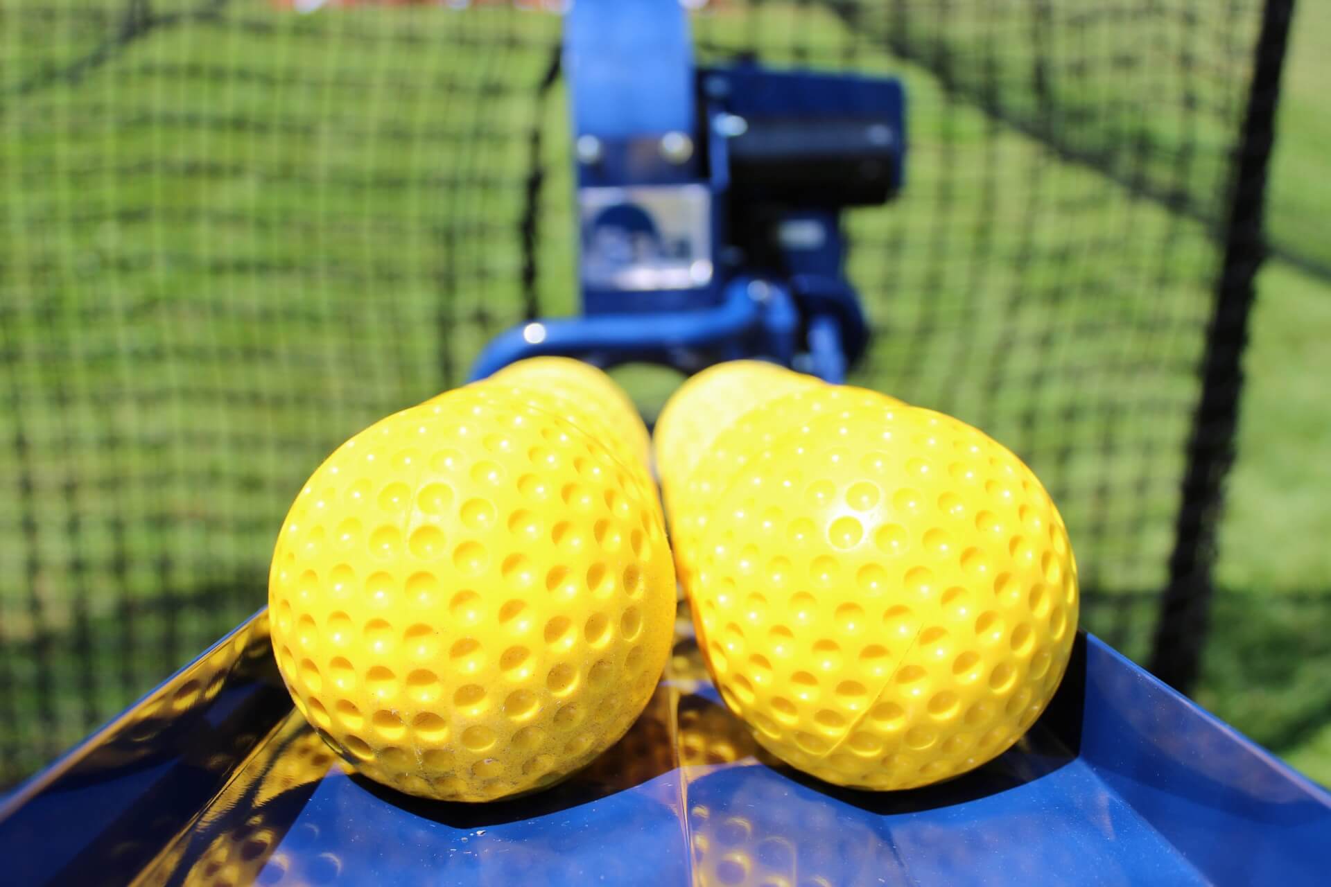 Bata auto feeder loaded with yellow dimpled softballs