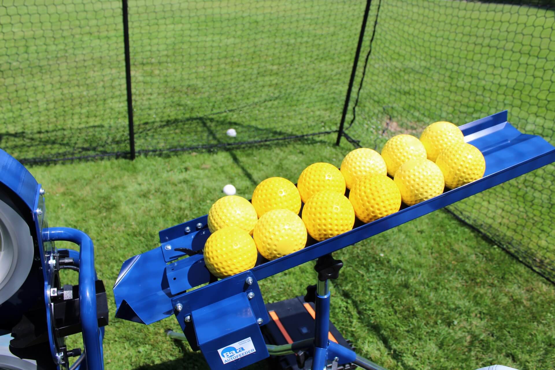 Bata auto feeder loaded with yellow dimpled softballs
