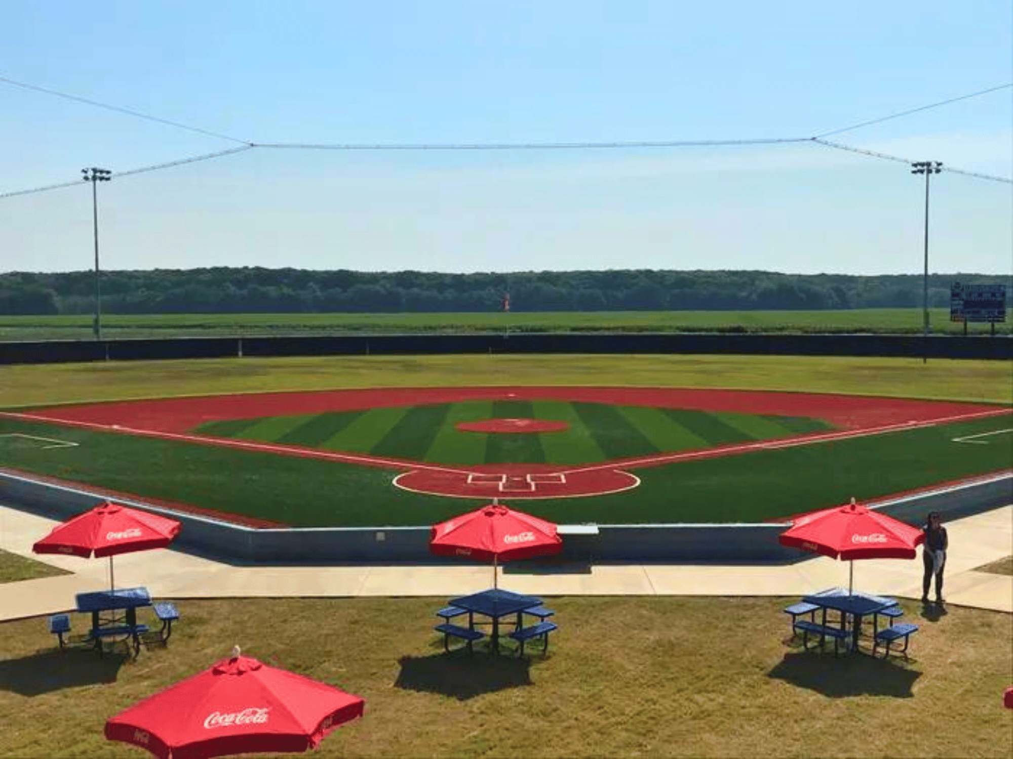 Close up of behind homeplate backstop netting with chairs and tables