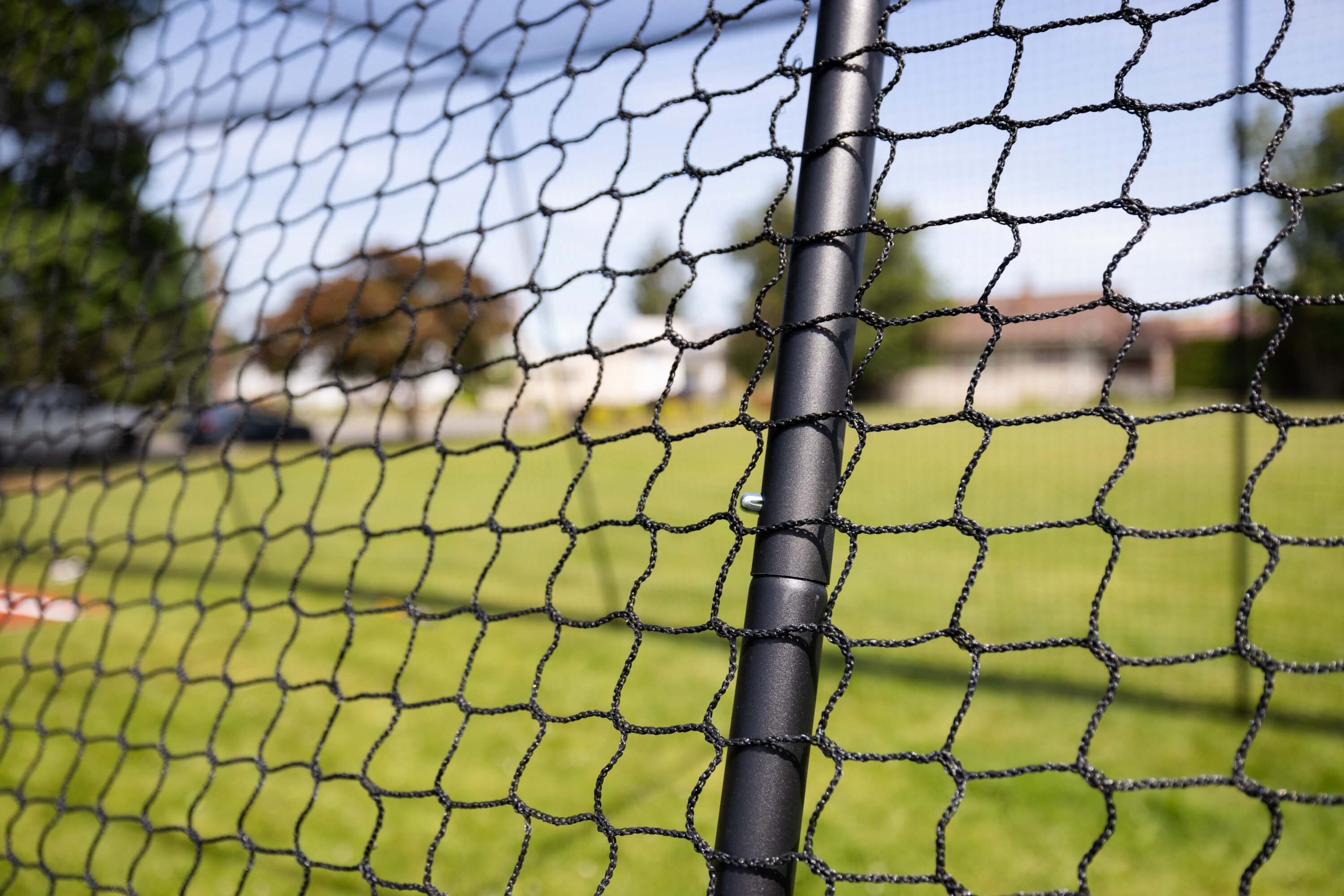 Batting cage netting over the frame poles
