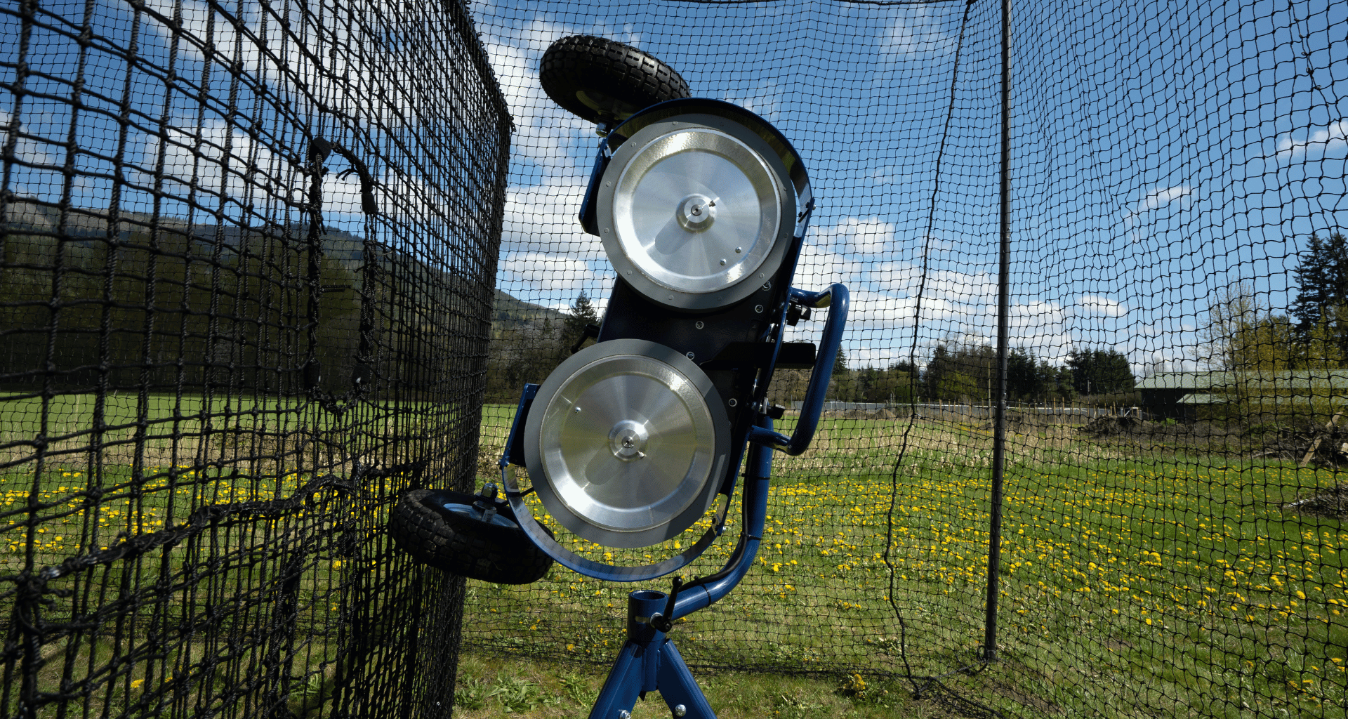 Bata 2 pitching machine in batting cage in front of pitching machine screen
