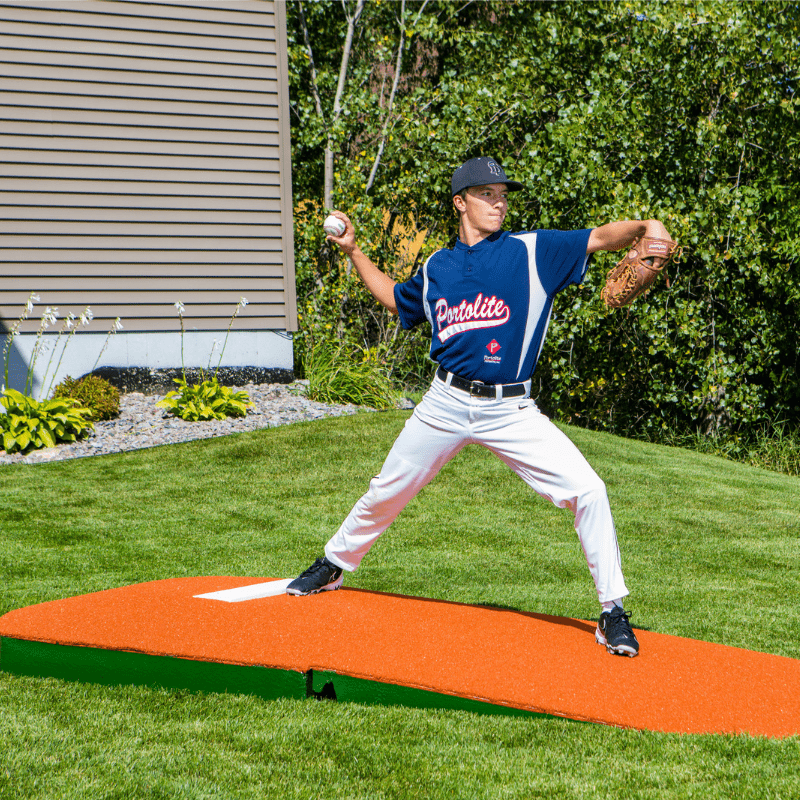 Man pitching off of the 2 Piece Indoor Practice Mound with Turf