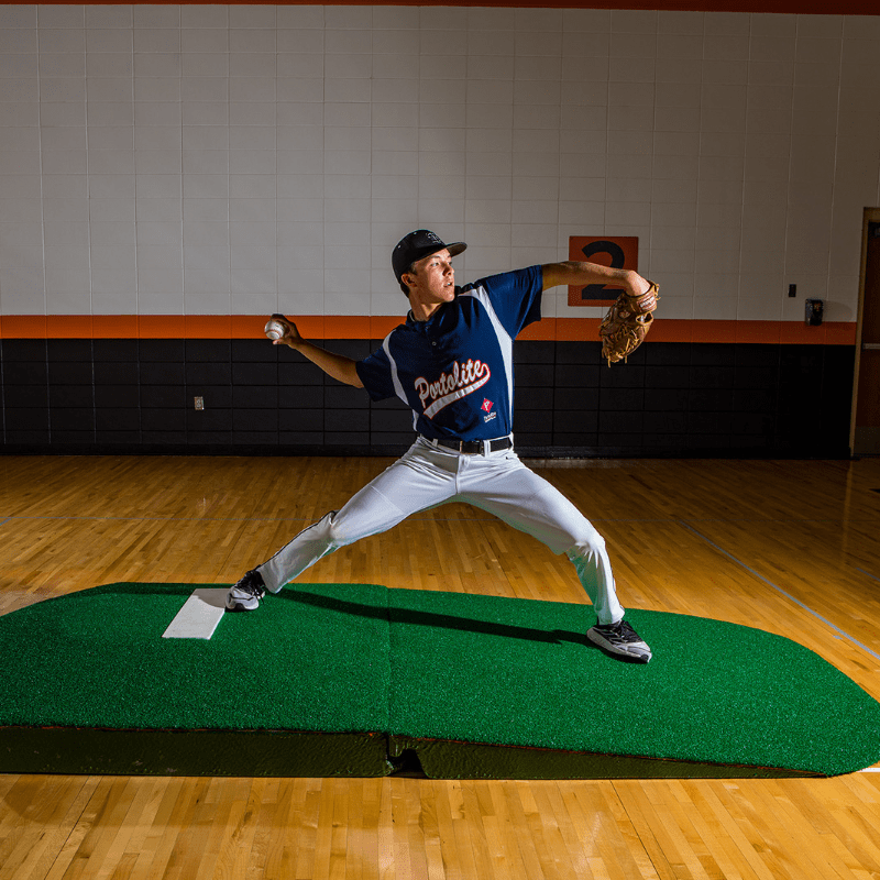 Man pitching off of the 10in Oversize Practice Mound with Turf Green