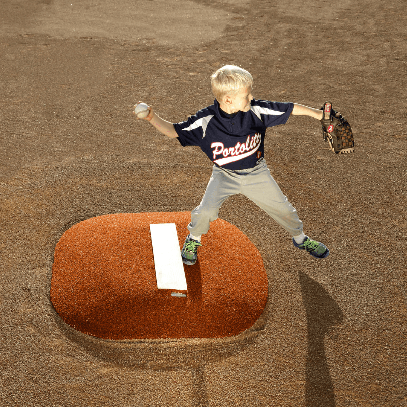 Boy pitching off of the Portolite 4in Stride Off Game Mound