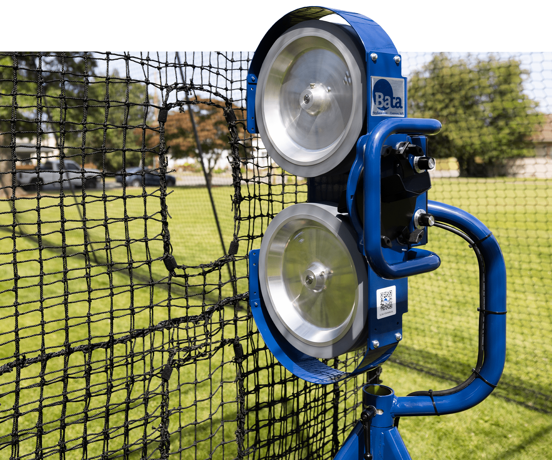 Bata 2 pitching machine behind pitching machine screen in batting cage