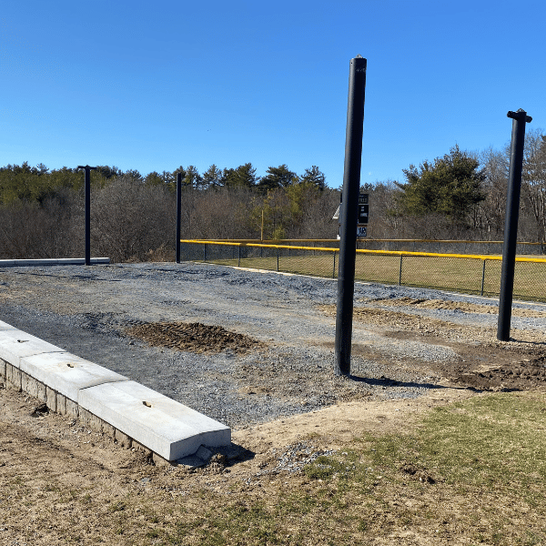 The Mastodon batting cage being installed at a park with currently only four poles in the ground