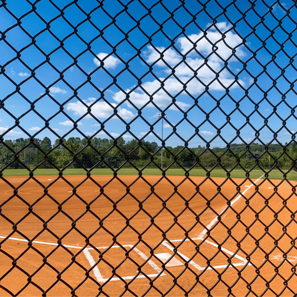Chain Link backstop behind home plate at baseball field