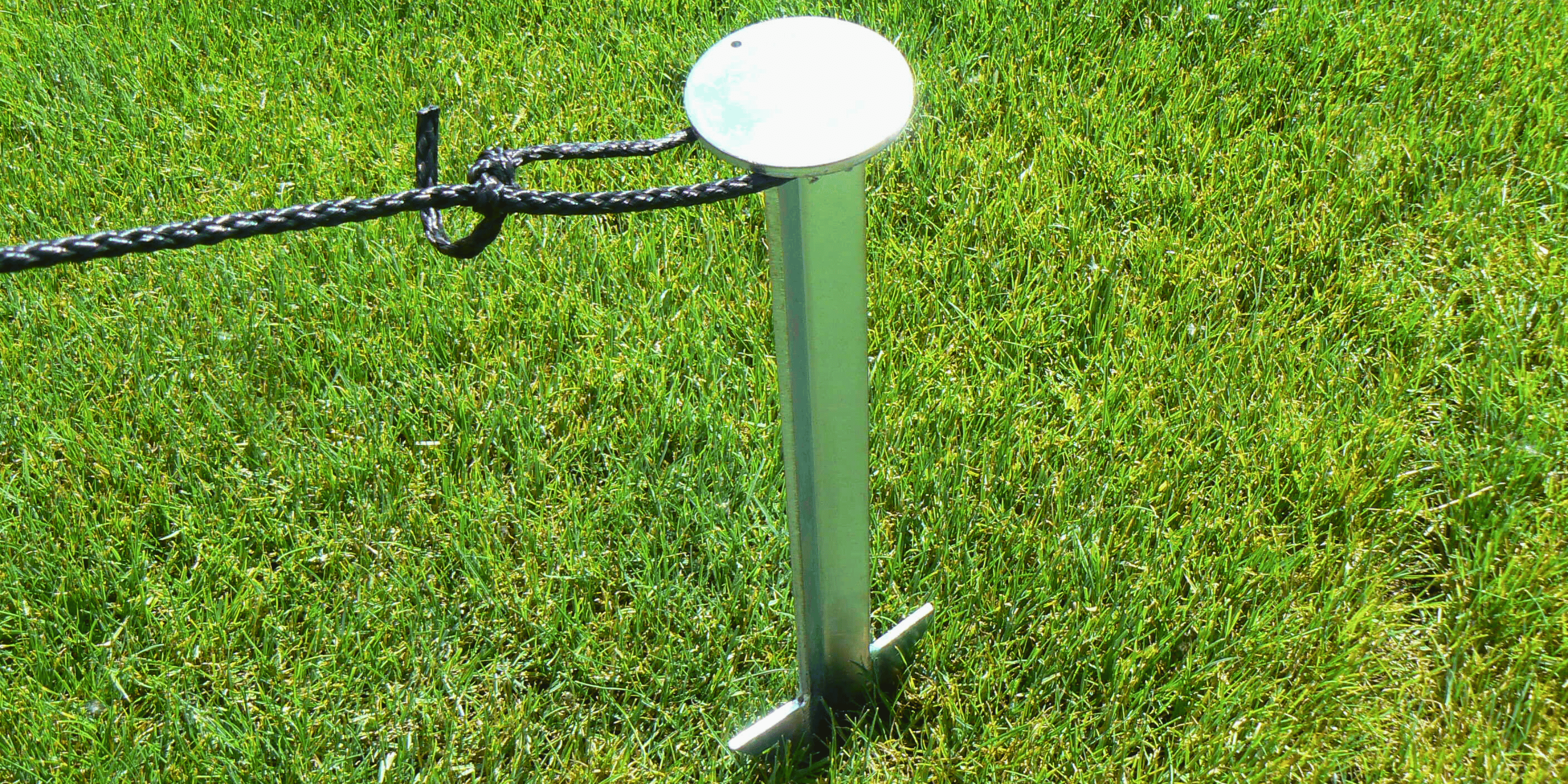 Heavy duty stake hammered into the ground with rope attached