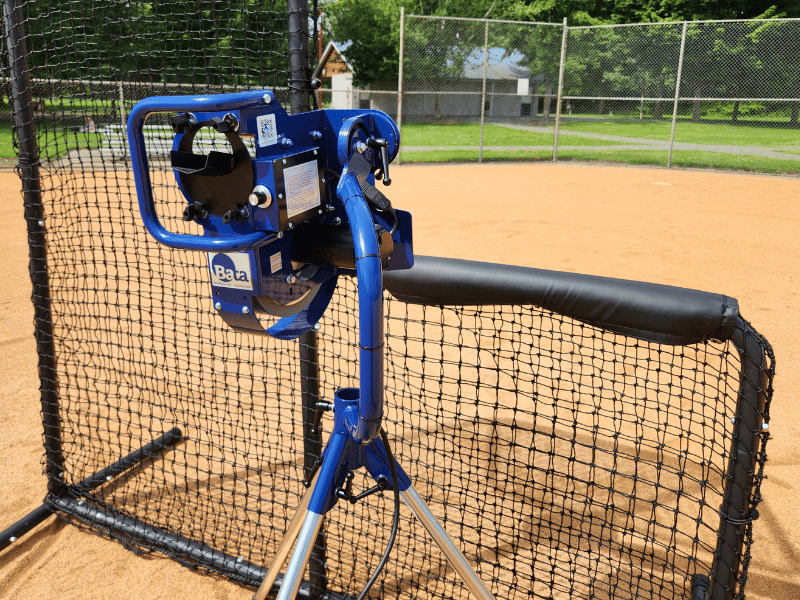 Bata B1 Curveball Pitching Machine behind the Armadillo L-Screen