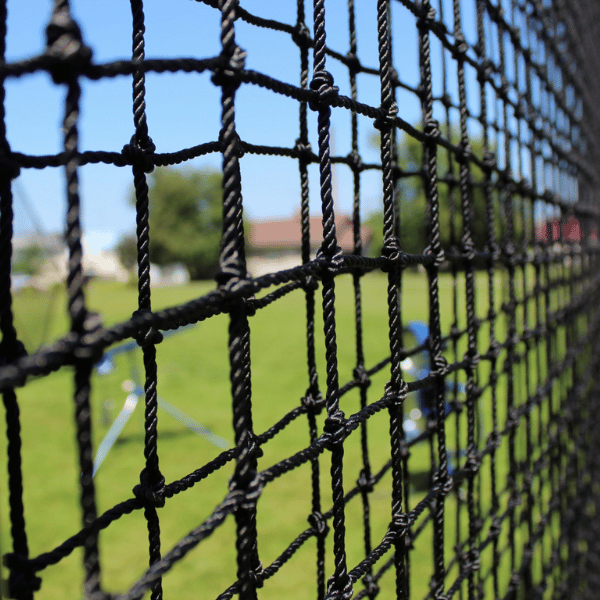 Nylon Pitching Machine Protective Square Screen netting close up with pitching machines and green grass 