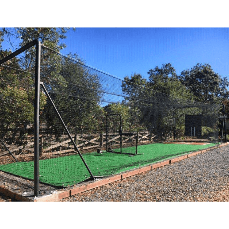 Iron Horse Batting Cage System with trees, blue skies, the armadillo, and deluxe batters box mat inside