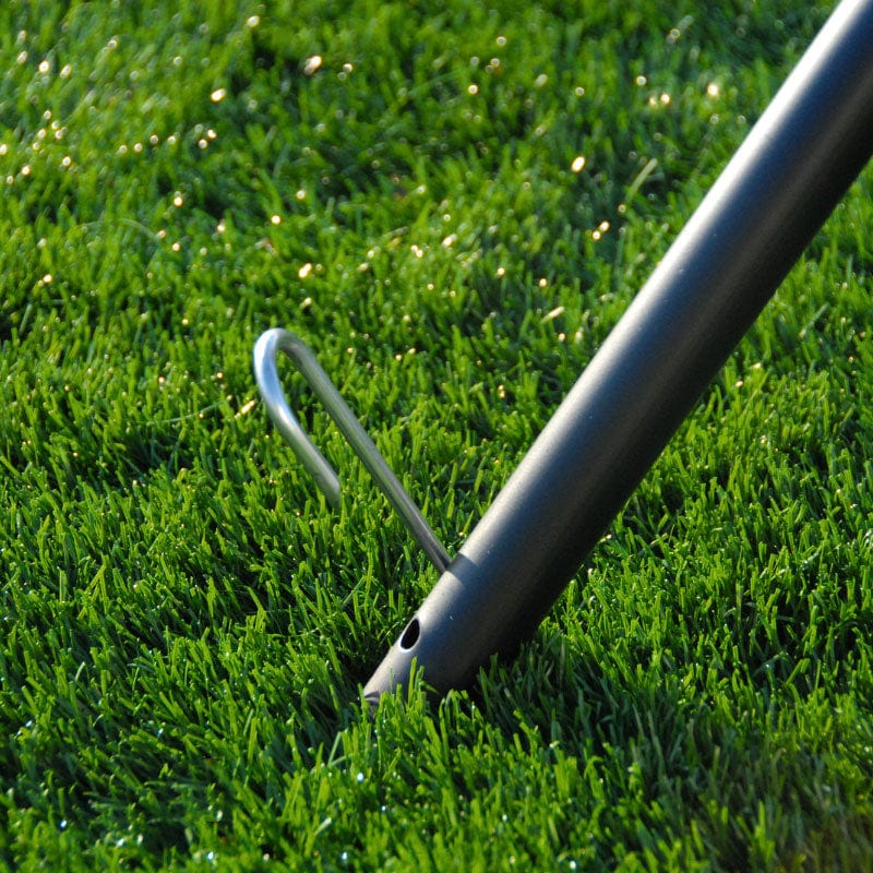 Trapezoid Batting Cage stakes put into the ground and poles