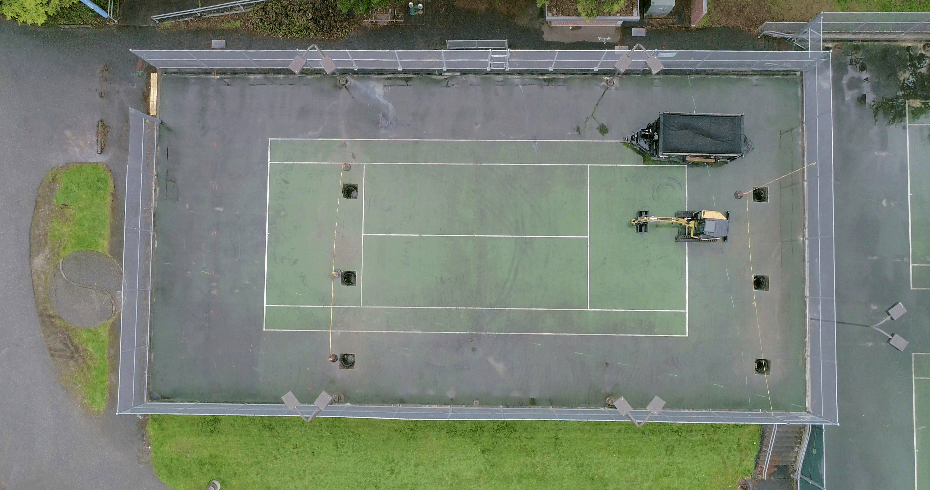 Birdseye view of tennis court where a new mastodon double stall cage will be at western washington university