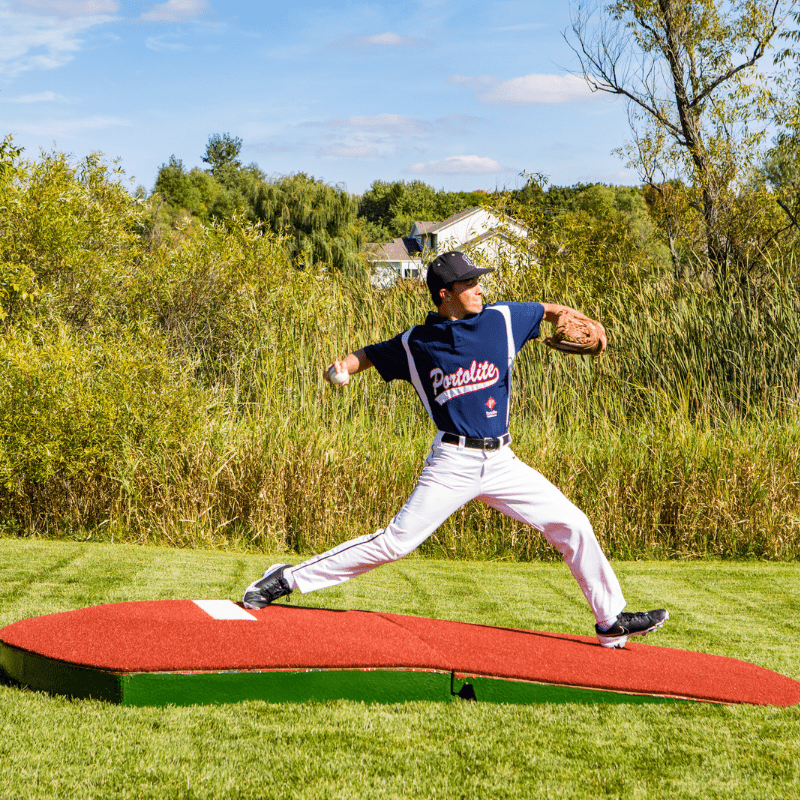 Man pitching off of the 10in Oversize Practice Mound with Turf