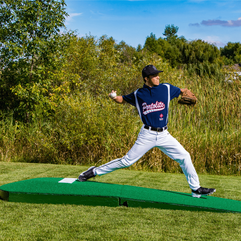 Man pitching off of the 2 Piece Indoor Practice Mound with Turf