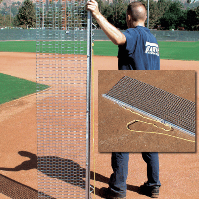 Man holding up the Rigid Drag Mat on baseball field