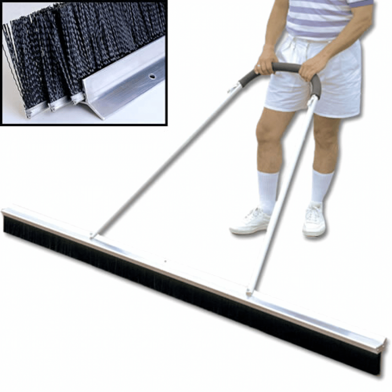 Man pulling the 3-Row Monster Baseball Field Broom 84in